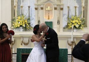 Image of Claudia and Donald embracing on their wedding day