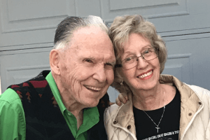 Image of Joe and Evelyn smiling and leaning towards each other