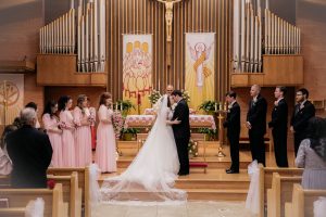 Image of Matthew and Alisha kissing in the church on their wedding day