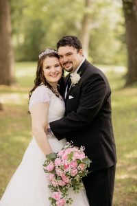 Image of Matthew and Alisha outside on their wedding day.