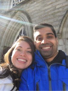 Image of couple taking a selfie in the sun outside of a church