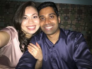 Image of couple sitting on couch taking a selfie
