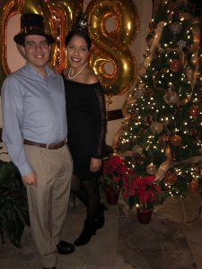 Image of couple near a Christmas tree ringing in the new year 2018
