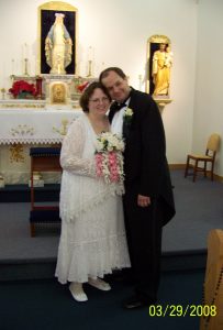 Image of Paul and Rose in wedding attire at church