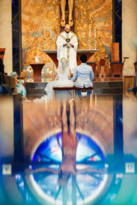 Image of bride and groom in church at wedding Mass
