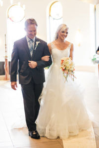 Image of bride and her father walking down the aisle