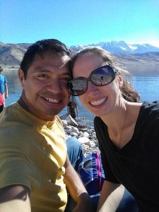 Image of couple with mountains and lake in background
