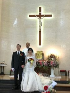 Image of couple standing in church on wedding day