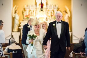 Image of couple walking out of church on wedding day