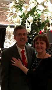 Image of couple inside near lilies