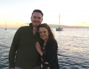 Image of couple smiling and hugging on boat