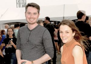 Image of couple in crowd, smiling at camera