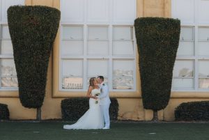 Image of couples kissing in wedding attire