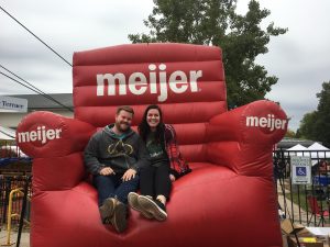 Image of couple sitting in giant red Meijer chair