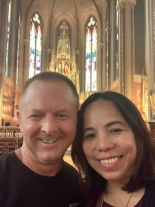 Image of Maggie and Brian smiling in a church