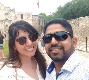 Image of couple in sunglasses outside. 
