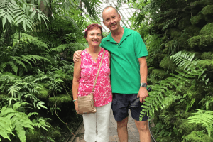 man and woman stand in forest