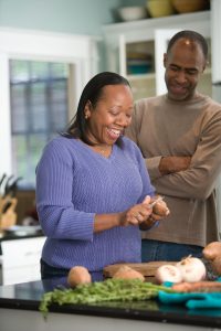 couple cooking together in kitchen 