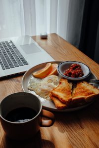 breakfast plate next to computer 