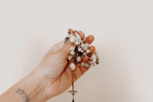 Person holding rosary