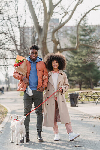 Couple walking dog